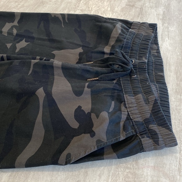Black camo pants. New. No tags. 2 side pockets. Elastic at ankles. 1 pocket back - Picture 2 of 4
